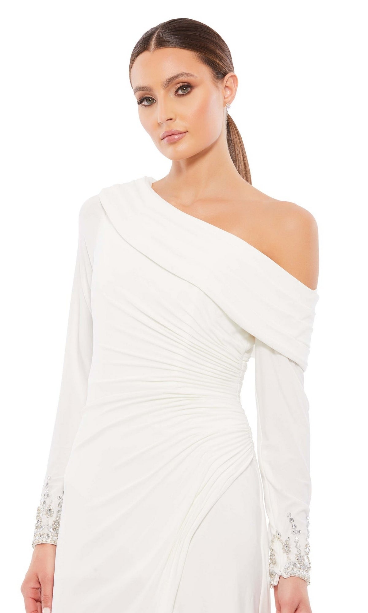 A woman stands against a plain white background wearing the Knee Length Party Dress 26485 by Mac Duggal, featuring a white drop shoulder design with ruched detailing and embellished cuffs.
